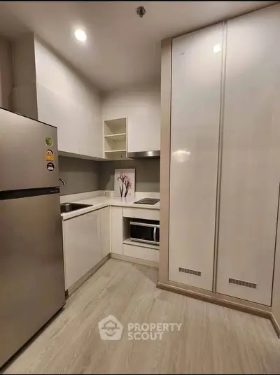 Modern kitchen with sleek cabinetry and built-in appliances in a stylish apartment.