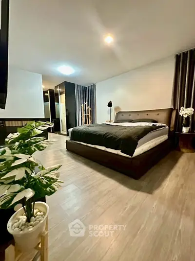 Spacious modern bedroom with elegant decor and cozy ambiance