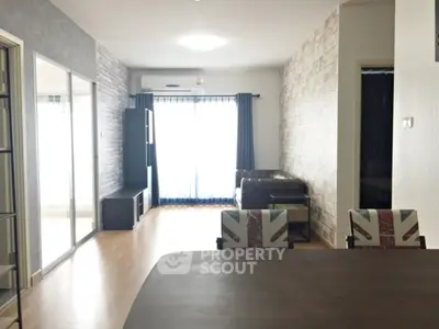 Modern living room with stylish decor and natural light in a contemporary apartment.