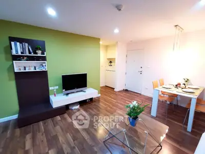 Modern living room with stylish decor and dining area, featuring wooden flooring and vibrant green accent wall.
