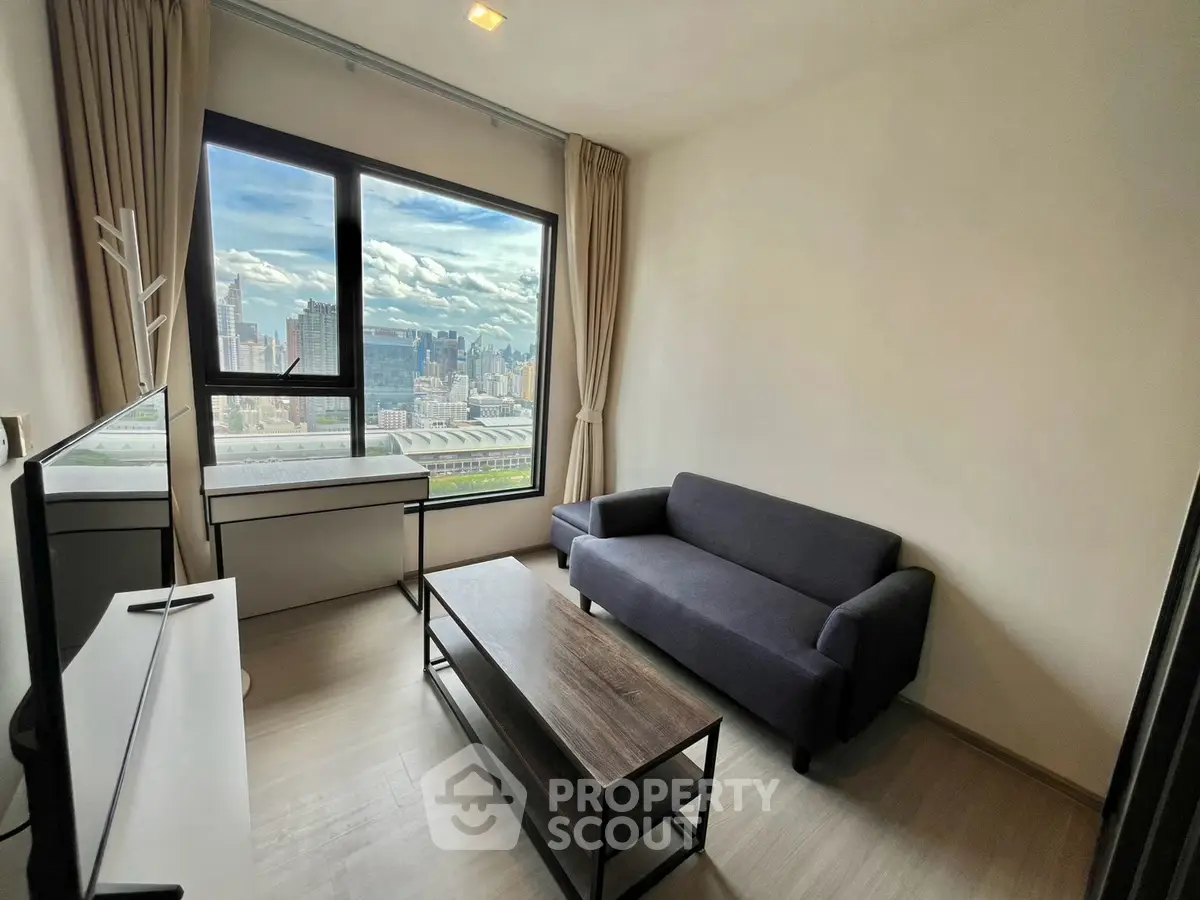 Modern living room with stunning city view, sleek furniture, and large window for natural light.