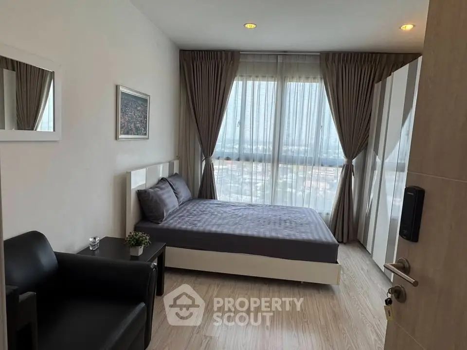 Modern bedroom with large windows and stylish decor in a high-rise apartment.