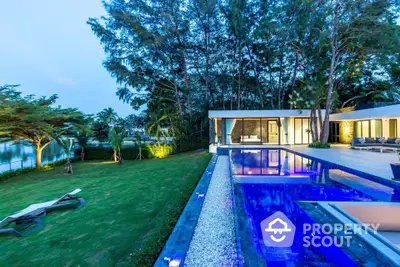 Luxurious modern villa with stunning pool and lush garden view