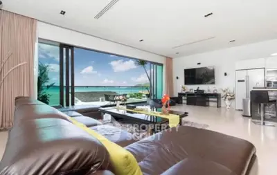 Luxurious living room with ocean view, modern furniture, and open layout in beachfront property.