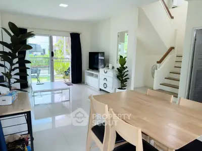 Spacious modern living room with dining area and garden view, perfect for family gatherings.