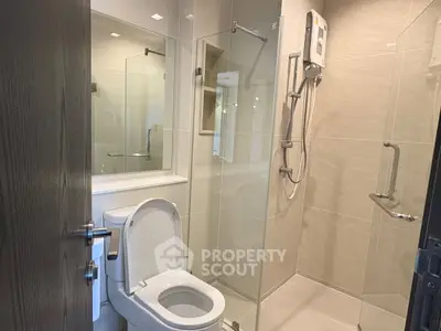 Modern bathroom with glass shower enclosure and sleek fixtures