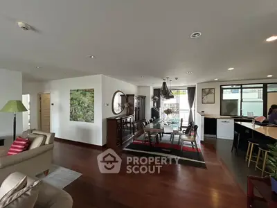 Spacious open-plan living and dining area with modern decor and natural light.