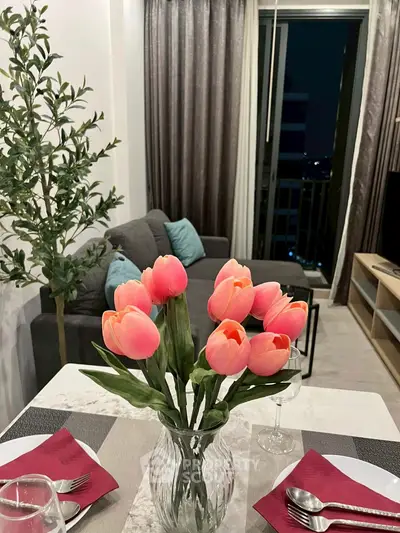 Chic modern living room with elegant dining setup and balcony view