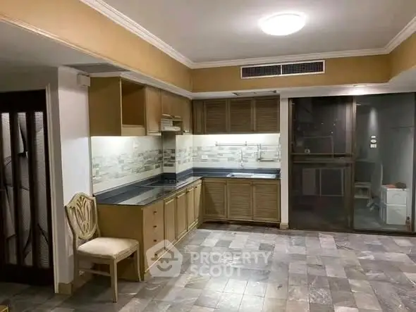 Spacious kitchen with modern design and ample storage in a stylish apartment.