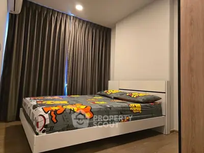 Modern bedroom with stylish decor and cozy ambiance, featuring a comfortable bed and elegant curtains.