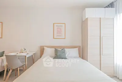 Bright and cozy bedroom with modern decor and ample natural light.