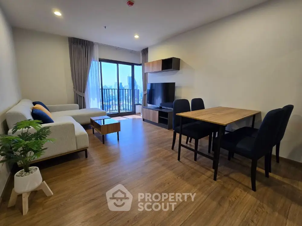 Modern living room with stylish furniture and city view balcony