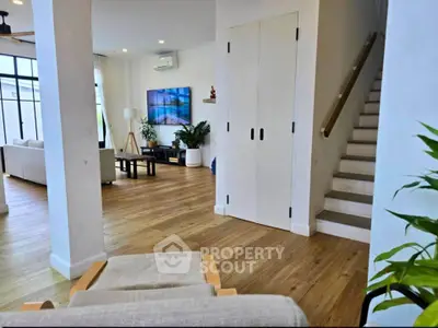 Spacious modern living room with wooden flooring and stylish decor
