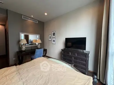 Elegant bedroom with stylish furniture and large window for natural light.