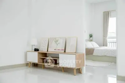 Modern minimalist bedroom with stylish decor and natural light