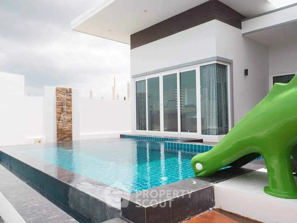 Modern villa with private pool and slide, perfect for family fun and relaxation.