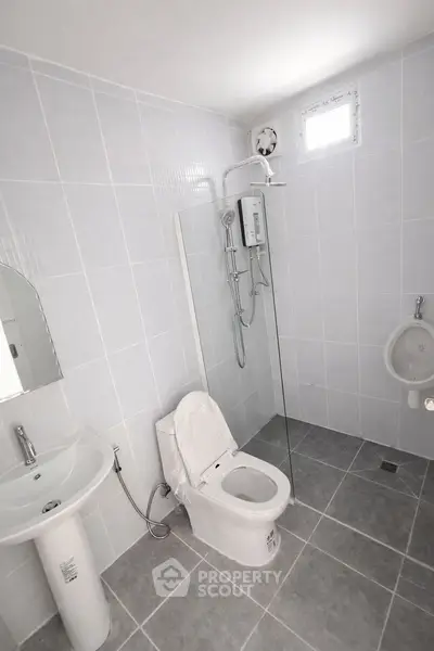 Modern bathroom with sleek fixtures and a spacious shower area.