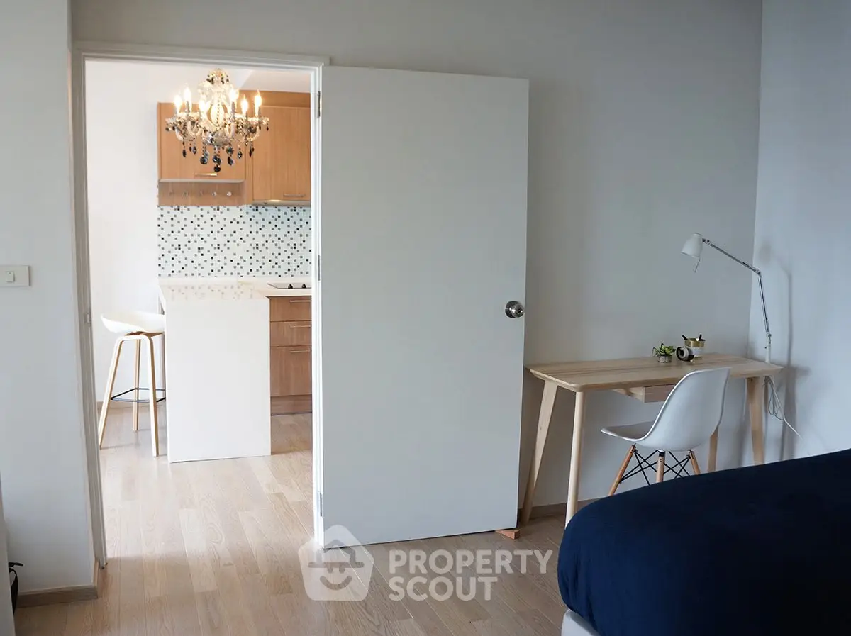 Modern apartment interior with open kitchen and cozy bedroom