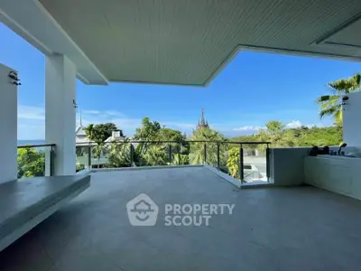 Spacious balcony with stunning tropical view and modern design.