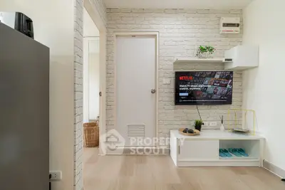 Modern living room with stylish decor and wall-mounted TV, perfect for cozy entertainment.