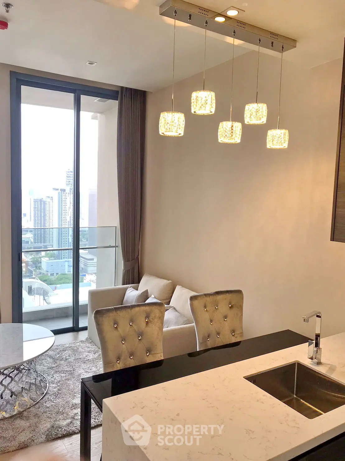 Modern living room with elegant lighting and city view balcony