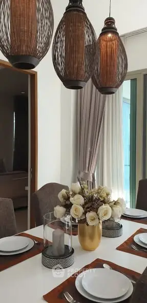 Elegant dining room with modern lighting and floral centerpiece