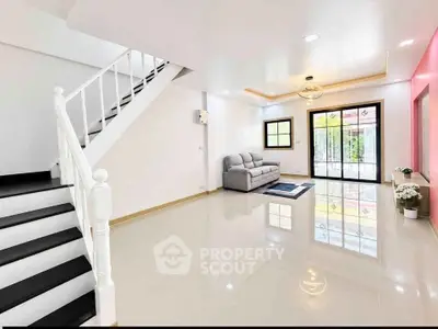 Spacious modern living room with sleek staircase and elegant decor
