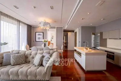 Luxurious open-plan living room and kitchen with elegant decor and modern appliances.