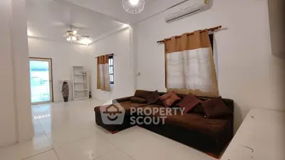 Spacious living room with modern sofa and air conditioning