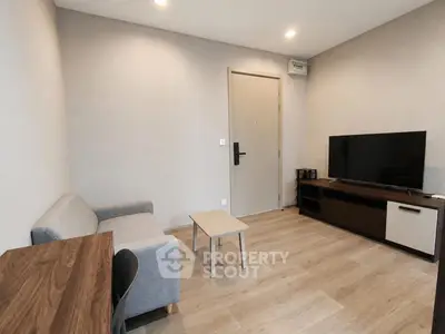 Modern living room with sleek furniture and flat-screen TV, perfect for relaxation and entertainment.