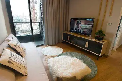 Modern living room with city view, stylish decor, and cozy ambiance.