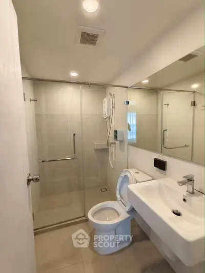 Modern bathroom with glass shower and sleek fixtures