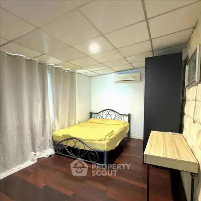 Cozy bedroom with modern design, featuring a stylish bed and elegant curtains, perfect for relaxation.