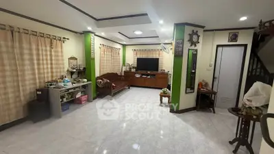 Spacious living room with modern decor and ample natural light.