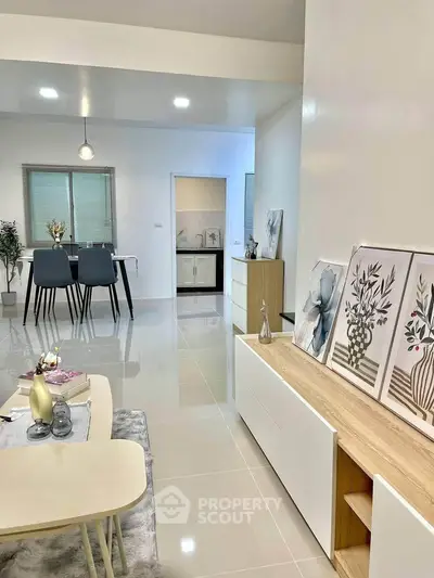 Modern open-plan living and dining area with stylish decor and sleek furniture.