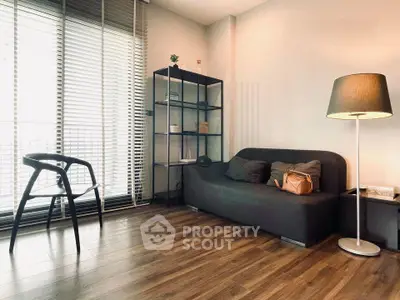 Modern living room with sleek furniture and large windows for natural light.