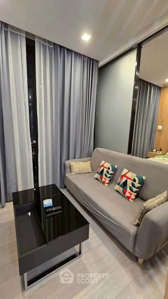 Modern living room with stylish sofa and sleek coffee table in a cozy apartment setting.