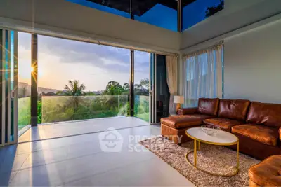 Luxurious living room with stunning sunset view and modern leather sofa