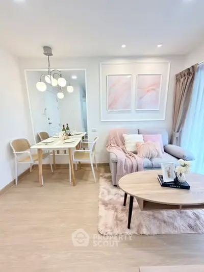 Stylish living room with modern decor and dining area, featuring elegant lighting and cozy furnishings.