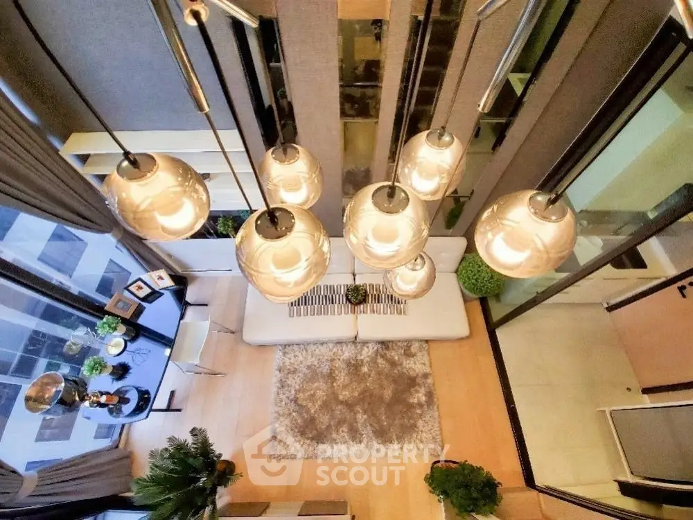 Stunning modern living room with high ceiling and elegant lighting fixtures