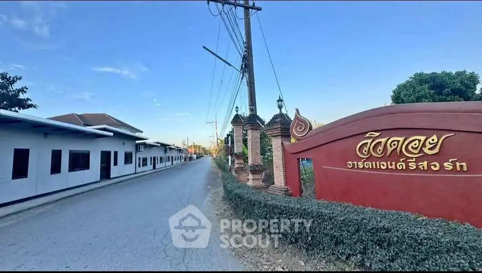 Charming residential entrance with traditional architectural elements and lush greenery.