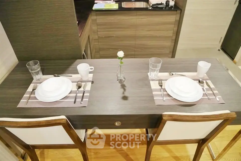 Stylish dining area with modern table setting in a cozy apartment kitchen.