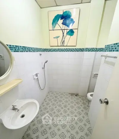 Compact bathroom with modern fixtures and artistic wall decor
