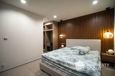 Modern bedroom with stylish wooden accent wall and cozy lighting