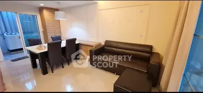 Modern living room with dining area and washing machine in cozy apartment