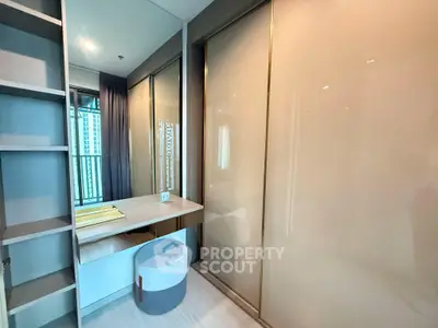 Modern bedroom with built-in wardrobe and vanity in high-rise apartment