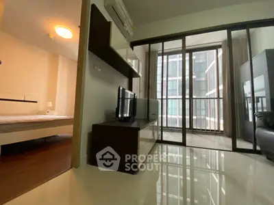 Modern apartment with sleek living room and bedroom, featuring floor-to-ceiling windows and a small balcony.