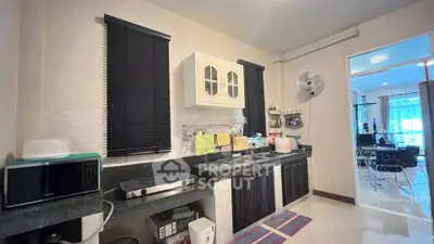 Spacious kitchen with modern appliances and open layout, perfect for culinary enthusiasts.