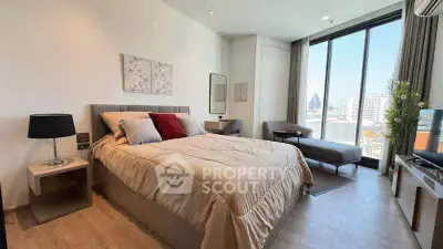 Luxurious bedroom with floor-to-ceiling windows and city view, featuring modern decor and cozy ambiance.