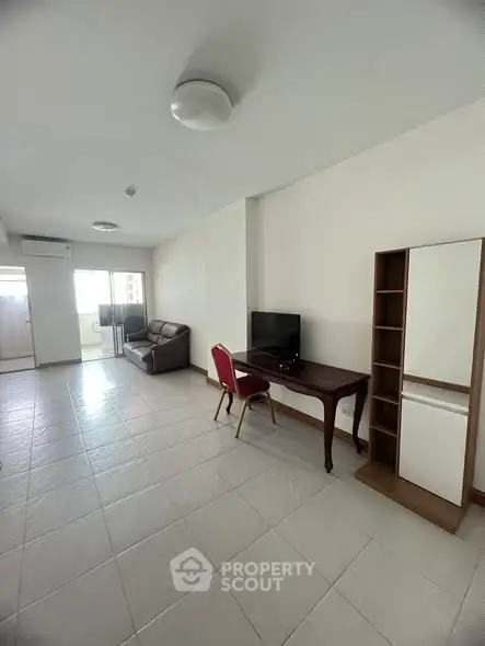 Spacious living room with modern furniture and natural light in a contemporary apartment.